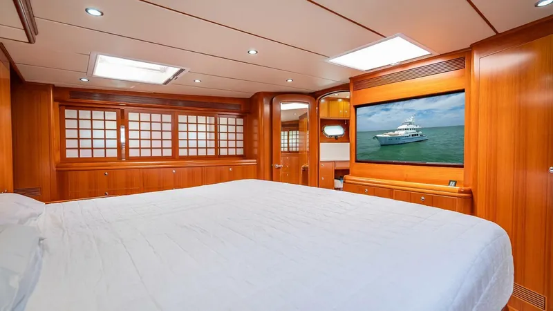 Slide: The Image of Luxurious bedroom interior of 2009 Nordhavn 76 yacht with wood paneling and large TV. - 33