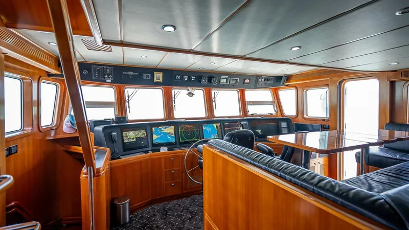 Slide: The Image of Luxurious 2009 Nordhavn 76 yacht interior with navigation equipment and wooden finishes. - 40