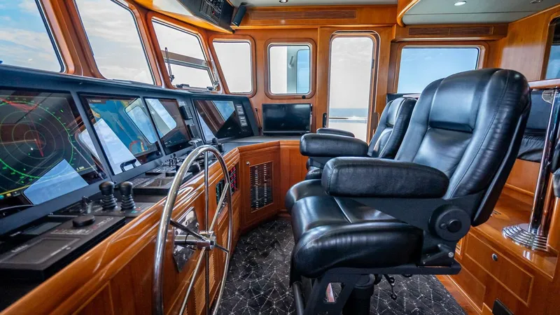 Slide: The Image of Pilothouse of 2009 Nordhavn 76 yacht with leather chairs and advanced navigation equipment. - 43