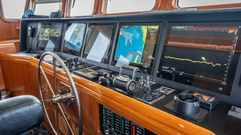 Slide: The Image of Navigation console of 2009 Nordhavn 76 yacht with multiple screens and controls. - 46