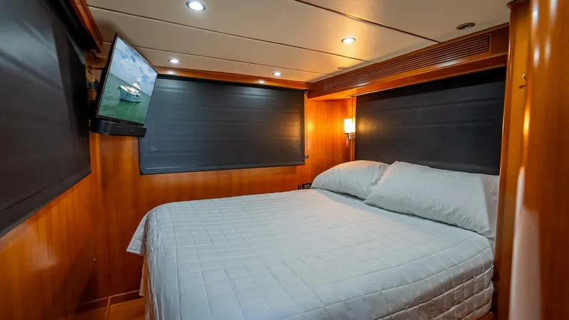 Slide: The Image of Luxurious cabin interior of 2009 Nordhavn 76 yacht with cozy bed and TV. - 49
