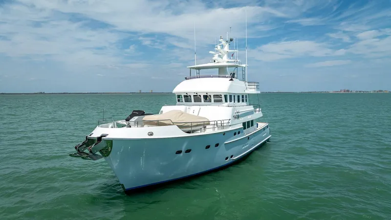 Slide: The Image of Luxurious 2009 Nordhavn 76 yacht cruising on calm waters under a clear blue sky. - 5