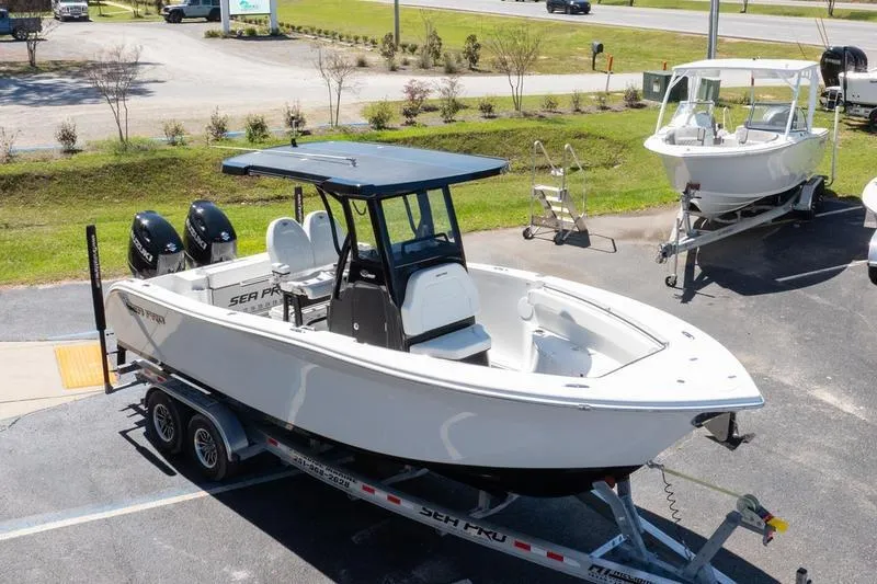 Slide: The Image of 2025 Sea Pro 262 Offshore boat on trailer, parked outdoors in a dealership lot. - 10