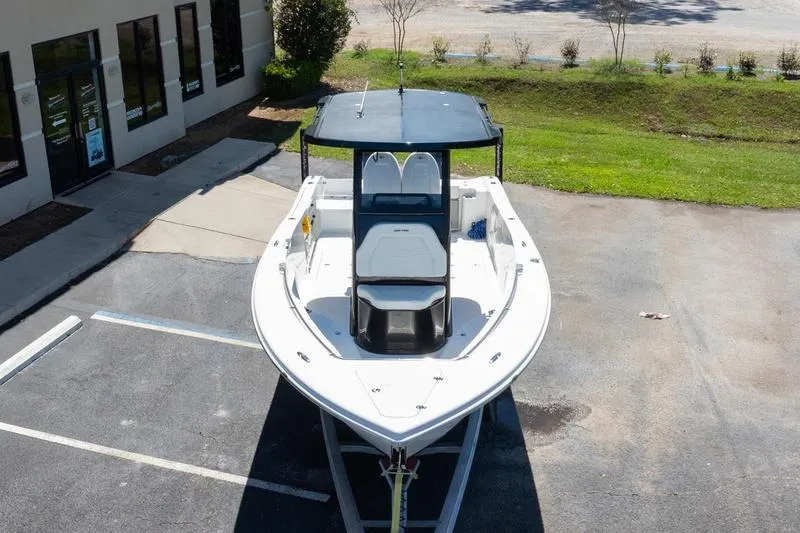 Slide: The Image of 2025 Sea Pro 262 Offshore boat parked outdoors, showcasing sleek design and spacious deck. - 14