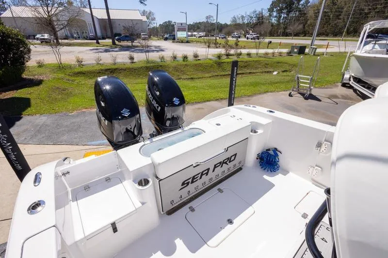 Slide: The Image of 2025 Sea Pro 262 Offshore boat with dual Suzuki engines, parked outdoors. - 21