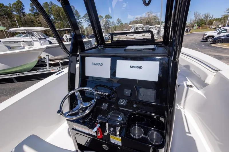 Slide: The Image of 2025 Sea Pro 262 Offshore boat dashboard with dual Simrad displays and steering wheel. - 30