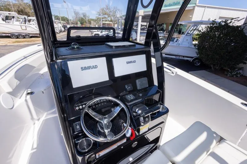 Slide: The Image of Helm of 2025 Sea Pro 262 Offshore boat with dual Simrad displays and steering wheel. - 32