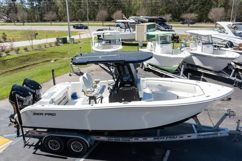 Slide: The Image of 2025 Sea Pro 262 Offshore boat on trailer, displayed in outdoor showroom. - 6