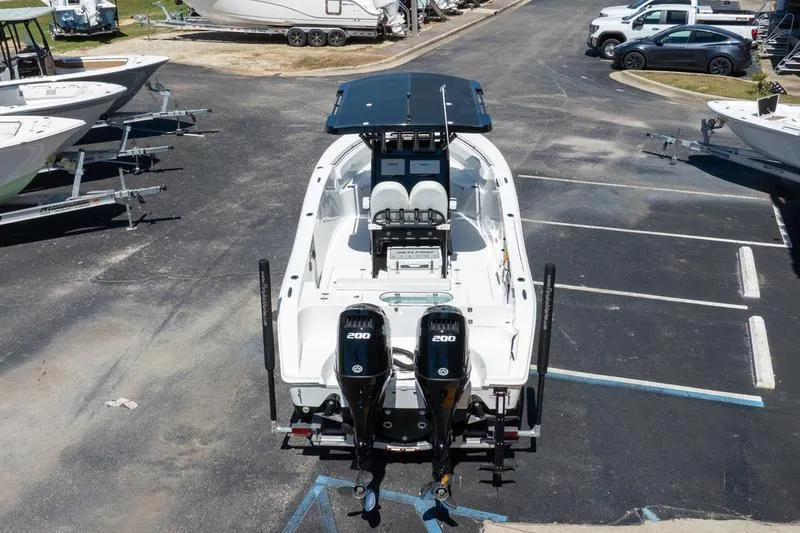 Slide: The Image of 2025 Sea Pro 262 Offshore boat with dual 200 horsepower engines in a parking lot. - 7