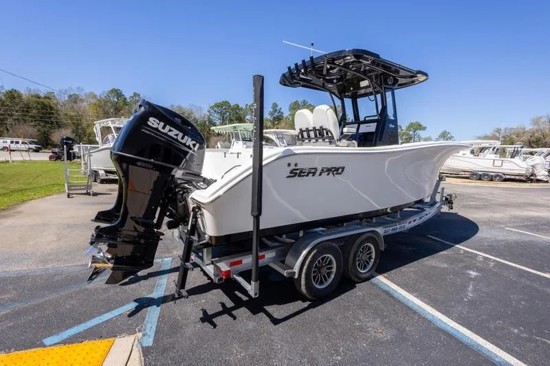 Slide: The Image of 2025 Sea Pro 262 Offshore boat on trailer with Suzuki outboard motor, parked outdoors. - 8