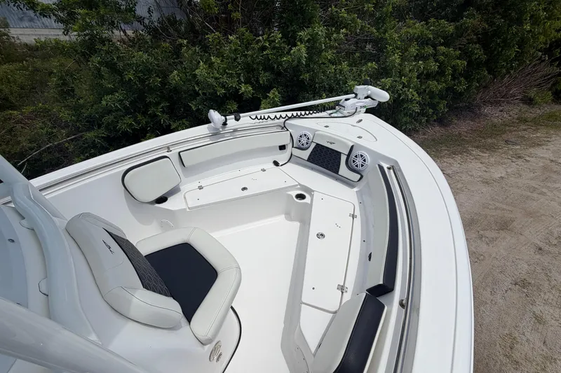 Slide: The Image of 2024 Tidewater 210 CC Adventure boat interior with seating and speakers. - 15