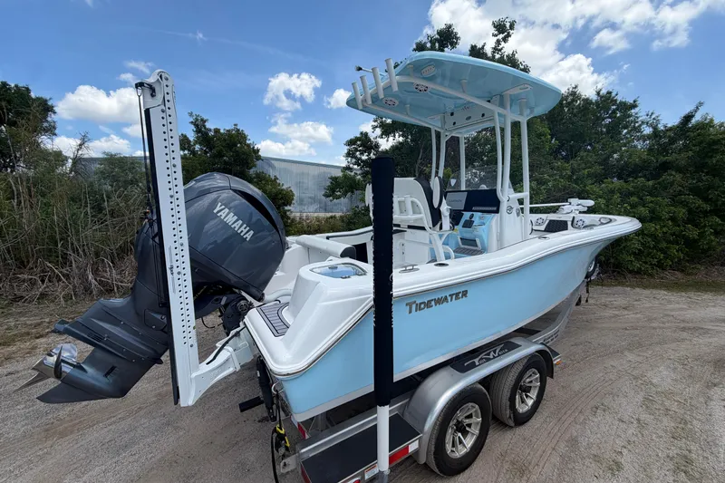 Slide: The Image of 2024 Tidewater 210 CC Adventure boat with Yamaha engine on trailer, outdoors. - 8