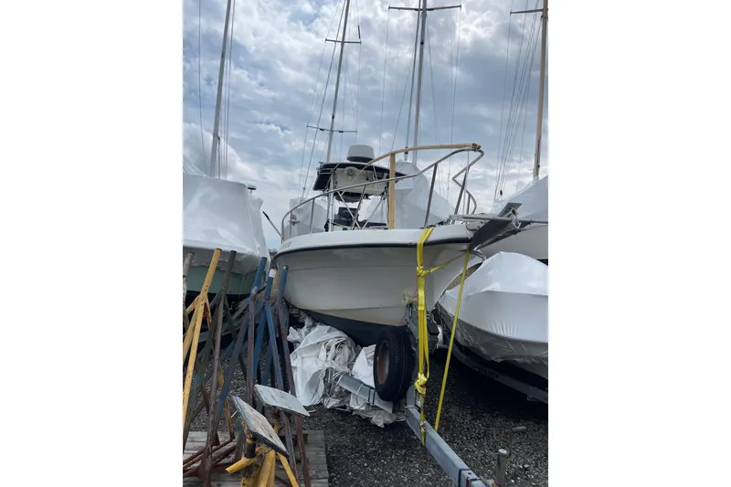 The Image of 2003 Hydra-Sports 230 Seahorse CC boat stored on a trailer, surrounded by other boats. - 0