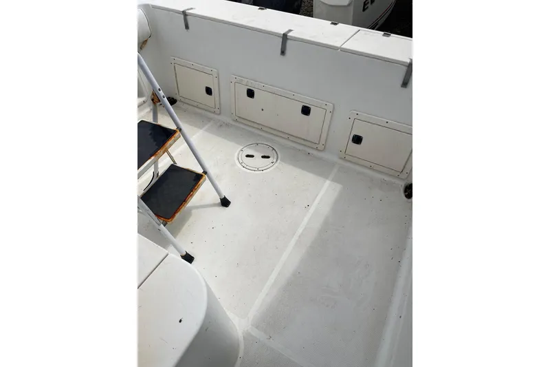 Slide: The Image of 2003 Hydra-Sports 230 Seahorse CC boat deck with storage compartments and ladder. - 10