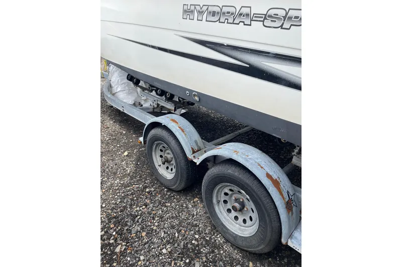 Slide: The Image of 2003 Hydra-Sports 230 Seahorse CC boat on a trailer with visible rust. - 11