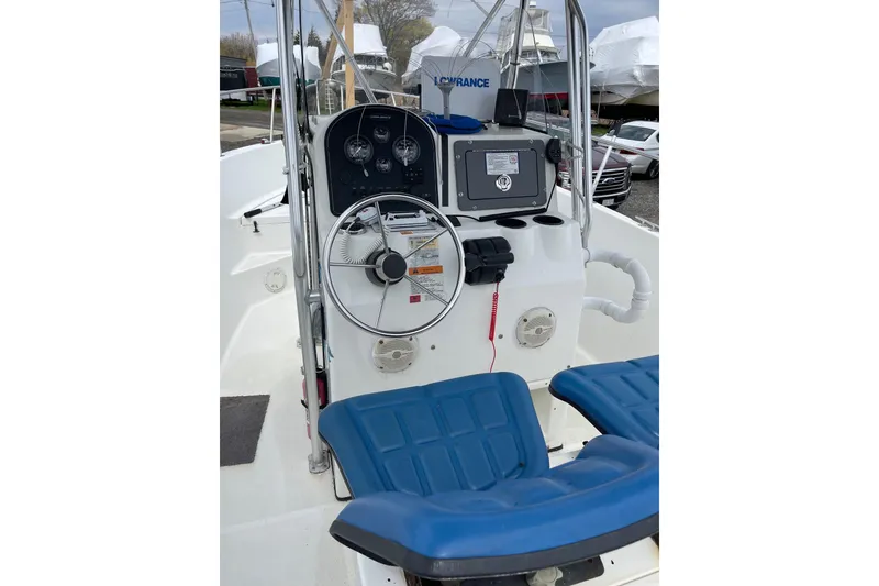 Slide: The Image of 2003 Hydra-Sports 230 Seahorse CC boat console with steering wheel and navigation equipment. - 2