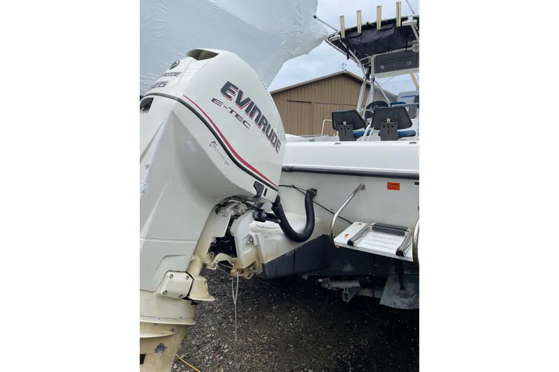 Slide: The Image of 2003 Hydra-Sports 230 Seahorse CC with Evinrude E-TEC outboard motor, docked outdoors. - 3