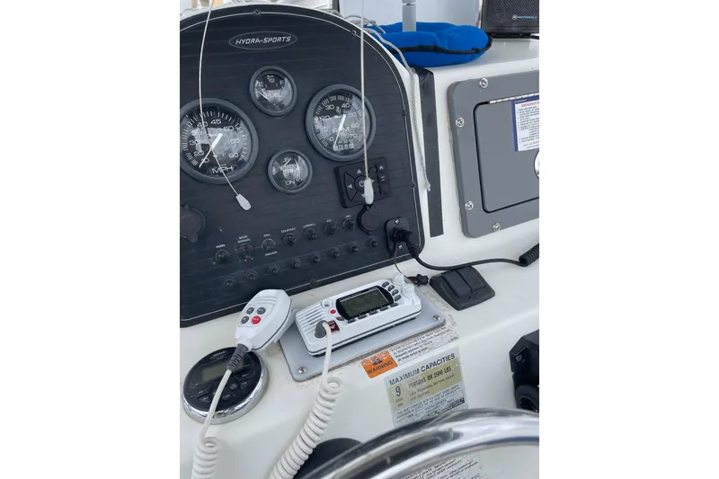 Slide: The Image of 2003 Hydra-Sports 230 Seahorse CC dashboard with gauges and marine radio. - 5