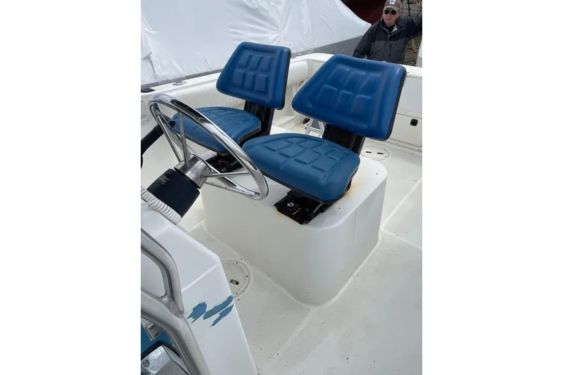 Slide: The Image of 2003 Hydra-Sports 230 Seahorse CC boat with blue seats and steering wheel. - 6