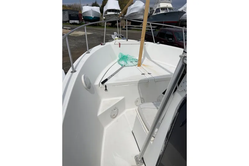 Slide: The Image of 2003 Hydra-Sports 230 Seahorse CC boat deck with fishing net and storage compartments. - 7