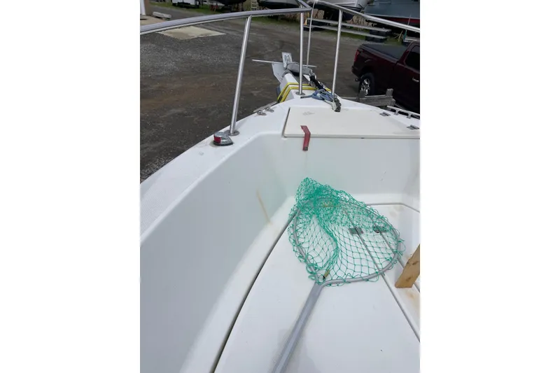 Slide: The Image of 2003 Hydra-Sports 230 Seahorse CC boat deck with fishing net and railing. - 8