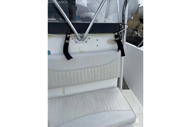 Slide: The Image of 2003 Hydra-Sports 230 Seahorse CC boat seat with white upholstery and safety straps. - 9