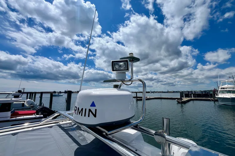 Slide: The Image of 2019 Axopar 28 Cabin boat with Garmin equipment, docked under a cloudy sky. - 16