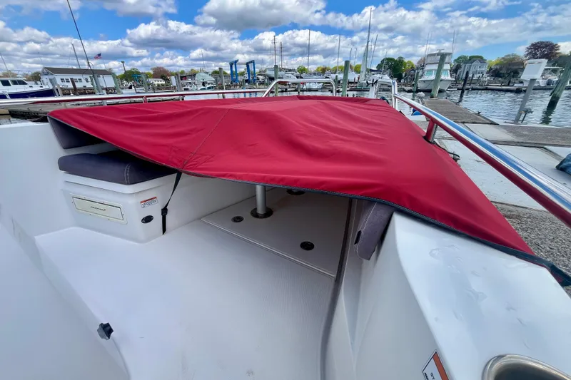 Slide: The Image of 2019 Axopar 28 Cabin boat with red cover at marina dock. - 17