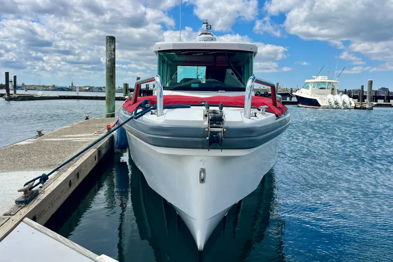 Slide: The Image of 2019 Axopar 28 Cabin boat docked at marina under blue sky. - 19