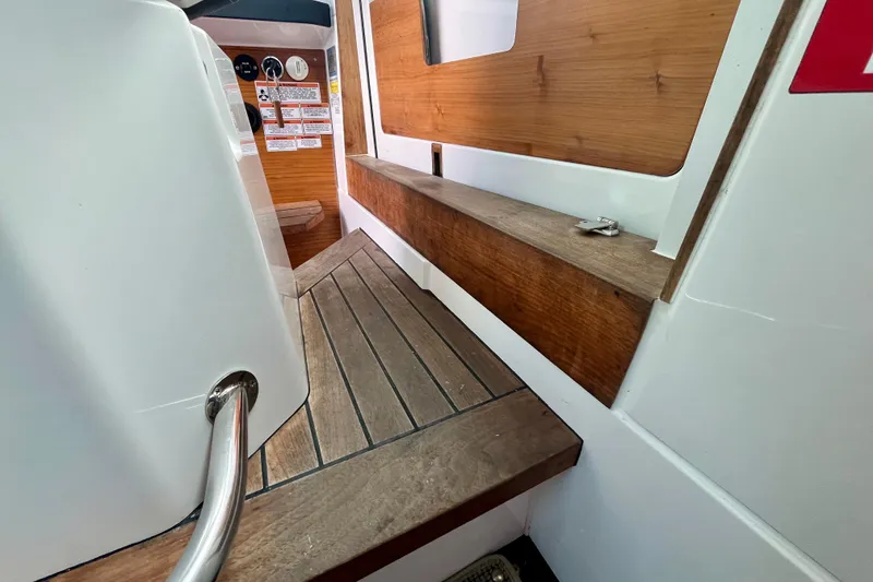 Slide: The Image of Interior view of 2019 Axopar 28 Cabin with wooden flooring and seating. - 20