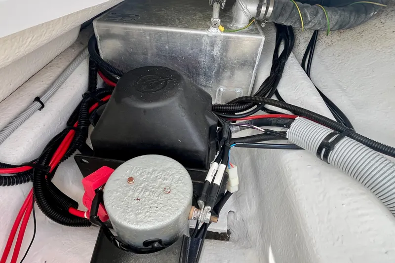 Slide: The Image of Engine compartment of a 2019 Axopar 28 Cabin boat, showing wiring and components. - 23