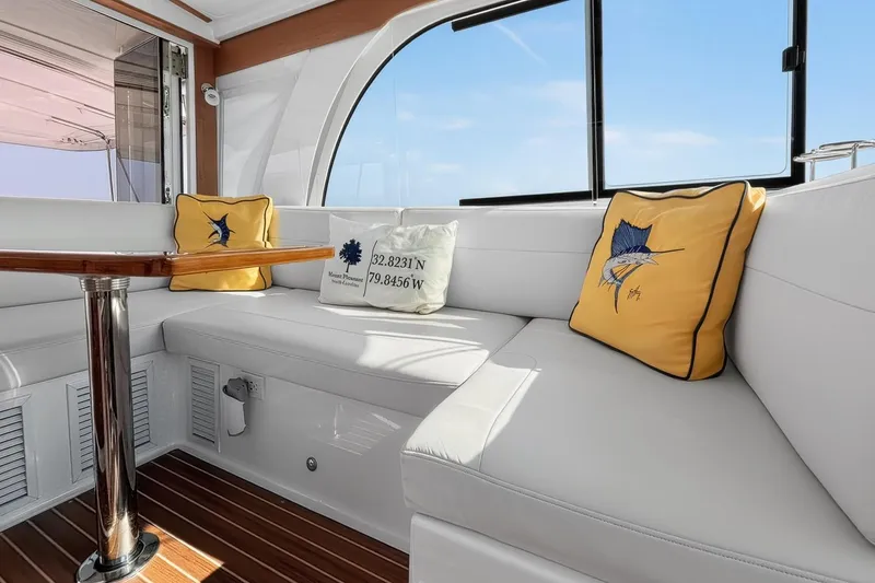 Slide: The Image of Luxurious interior of 2024 Back Cove 39O yacht with plush seating and decorative cushions. - 17