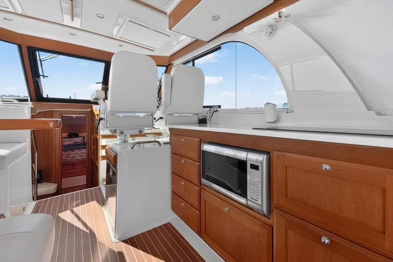 Slide: The Image of 2024 Back Cove 39O yacht interior with modern galley and seating area. - 19