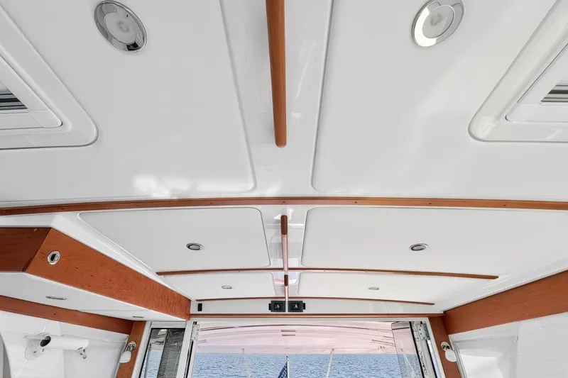 Slide: The Image of Ceiling view of 2024 Back Cove 39O yacht interior with wood accents and recessed lighting. - 24