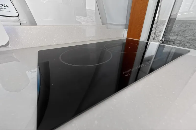 Slide: The Image of Sleek induction cooktop on 2024 Back Cove 39O yacht, featuring modern design and functionality. - 26