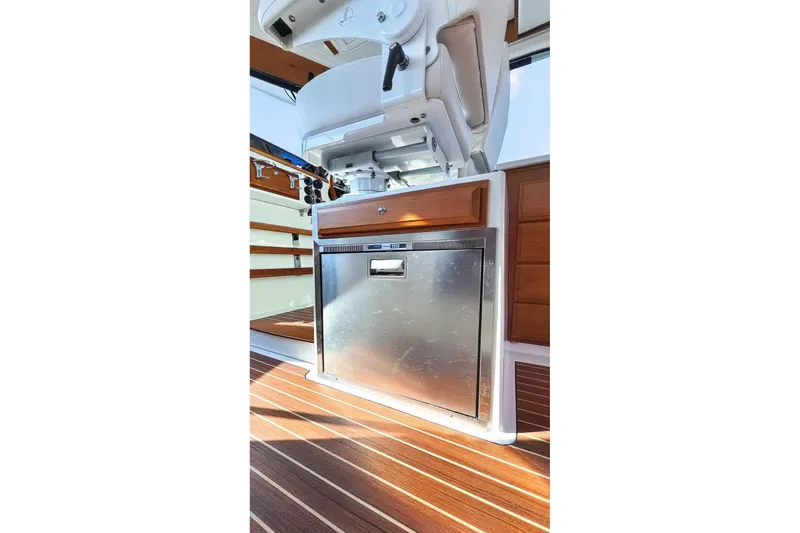Slide: The Image of 2024 Back Cove 39O interior with wooden flooring and stainless steel drawer style refrigerator  - 27