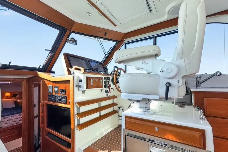 Slide: The Image of 2024 Back Cove 39O helm with luxurious seating and modern navigation controls. - 29