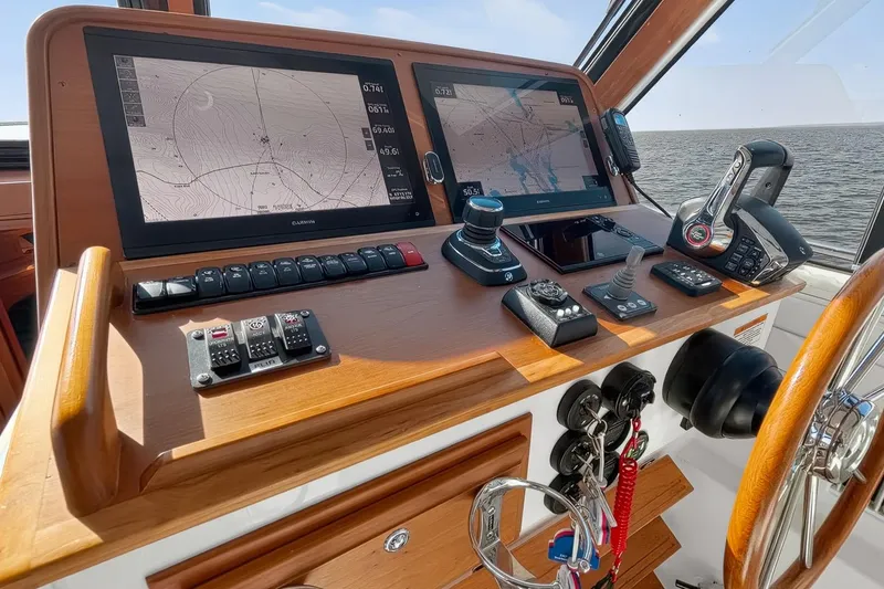 Slide: The Image of 2024 Back Cove 39O helm with dual navigation screens and control panel. - 31