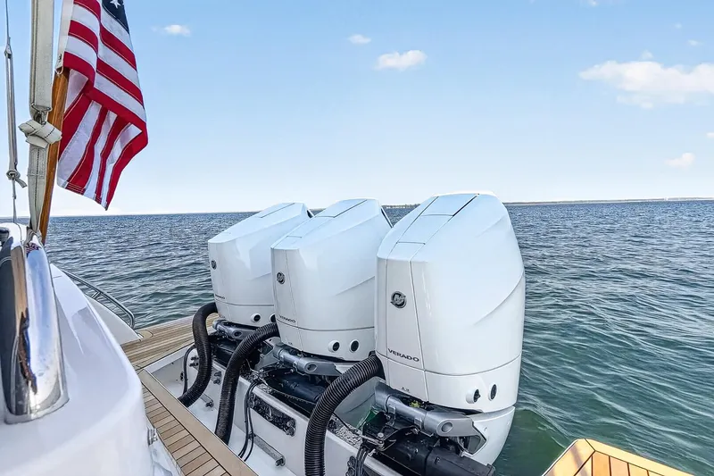 Slide: The Image of 2024 Back Cove 39O boat with triple Mercury V-10 400 HP engines on open water. - 5