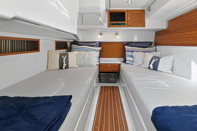 Slide: The Image of 2024 Back Cove 39O Mid cabin interior with twin beds and nautical decor. - 51