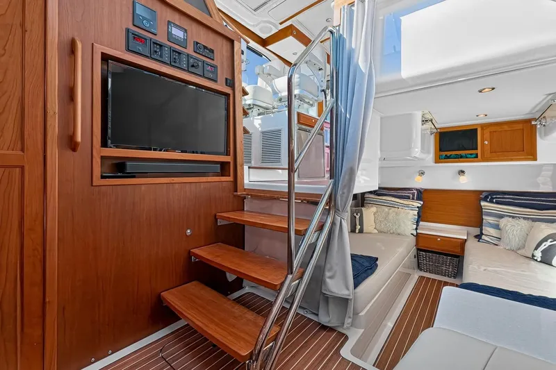 Slide: The Image of Luxurious lower deck seating area and access to mid cabin of 2024 Back Cove 39O Yacht - 54
