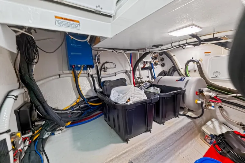 Slide: The Image of 2024 Back Cove 390 Yacht storage/mechanical compartment below helm station - 57