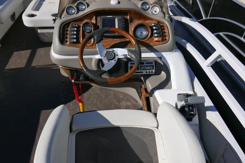 Slide: The Image of 2008 JC SunToon 21TT boat dashboard with steering wheel and control panel. - 10
