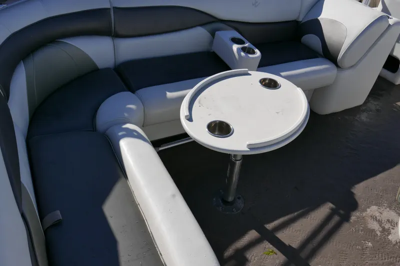 Slide: The Image of 2008 JC SunToon 21TT boat interior with seating and round table. - 11