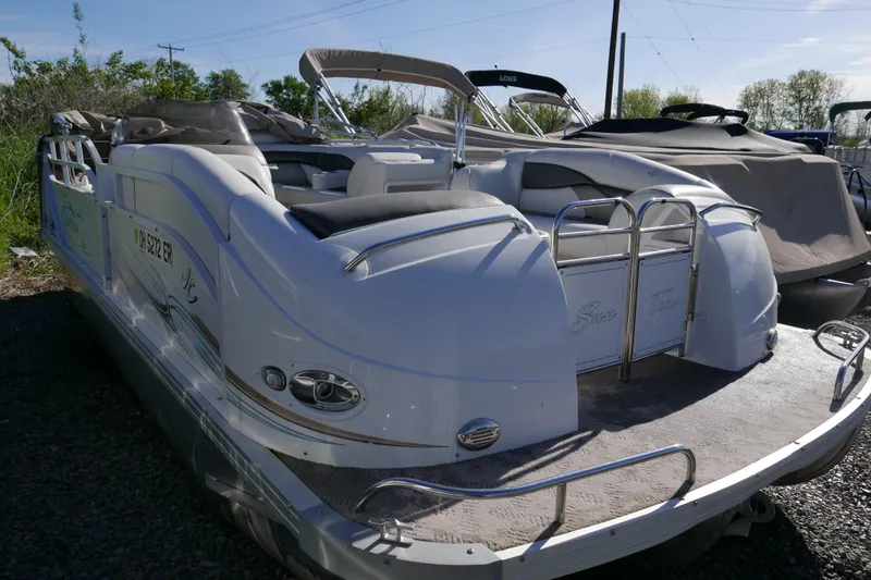 Slide: The Image of 2008 JC SunToon 21TT pontoon boat with sleek design, parked outdoors. - 2