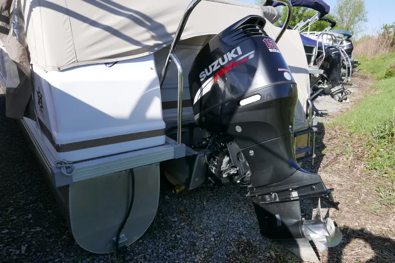 Slide: The Image of 2008 JC SunToon 21TT pontoon boat with Suzuki outboard motor on a grassy area. - 3