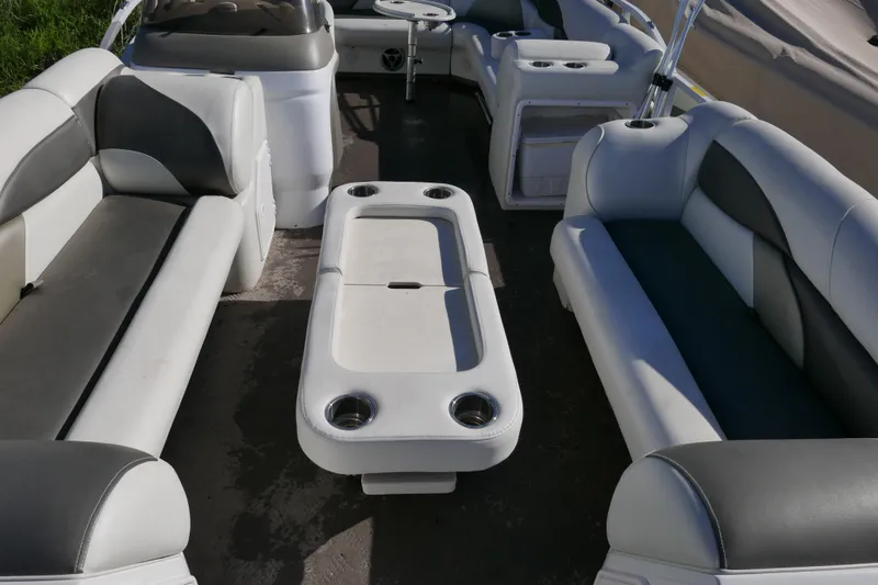 Slide: The Image of Interior of a 2008 JC SunToon 21TT pontoon boat with cushioned seating and table. - 4