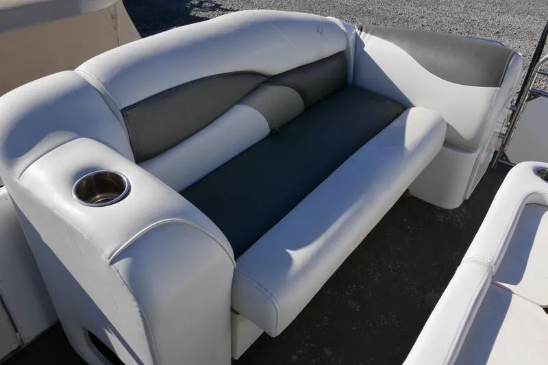 Slide: The Image of 2008 JC SunToon 21TT boat seating with cup holder, featuring gray and white upholstery. - 5