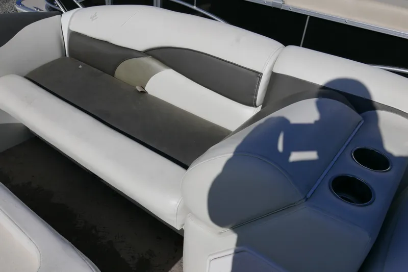 Slide: The Image of 2008 JC SunToon 21TT boat interior with white and gray seating, cup holders, and shadow. - 6