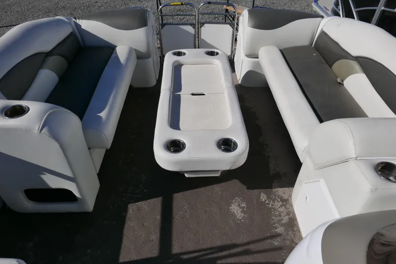 Slide: The Image of Interior of a 2008 JC SunToon 21TT pontoon boat with white seating and table. - 7